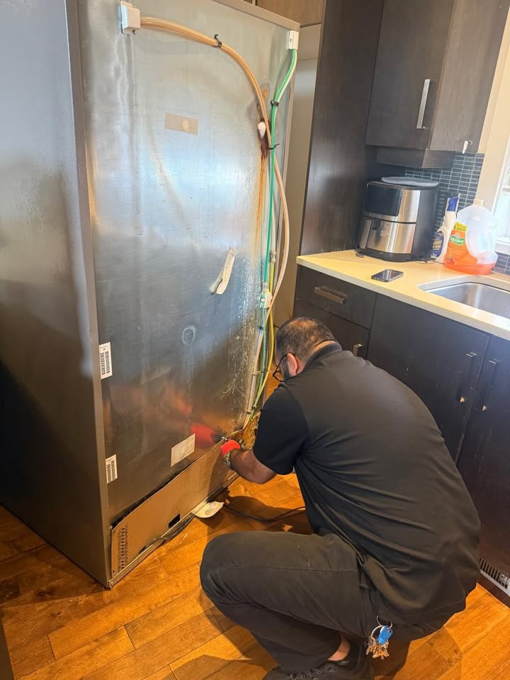 West Coast Wrench technician repairing a refrigerator in a Victoria BC home